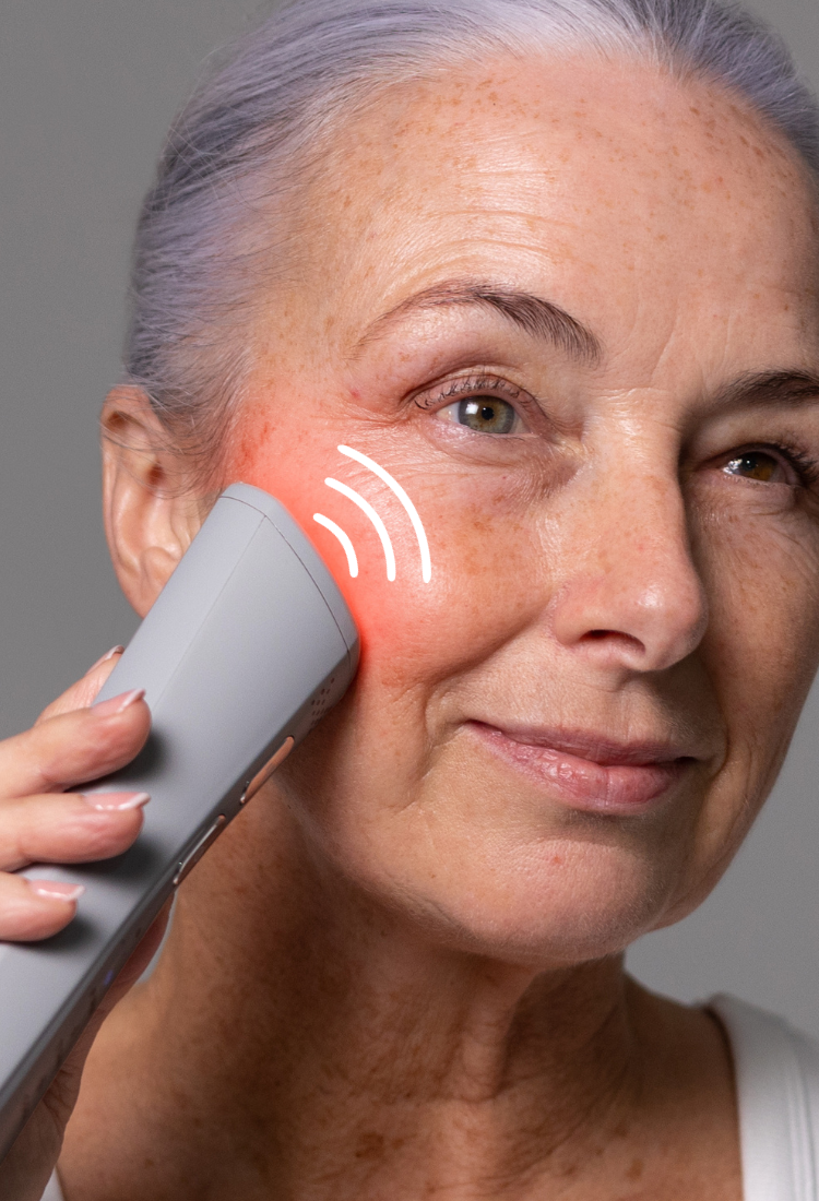 Model holding FaceRocket device to her cheek with illustration of radio waves coming from the device