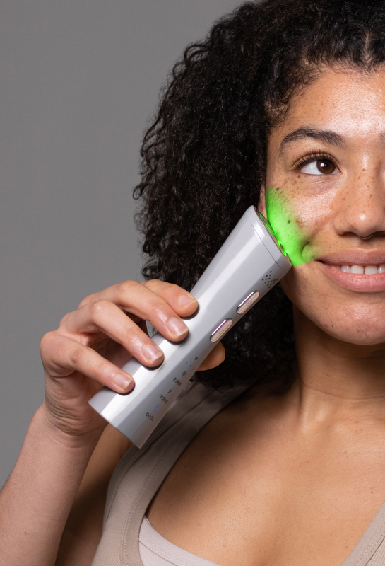 Model holding MAGNITONE FaceRocket to her cheek