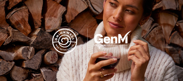DrinkWell x Gen M Partner | image of woman holding glass of red wine.
