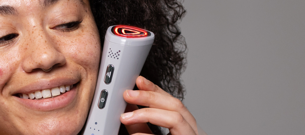 Model holding FaceRocket device up to her face