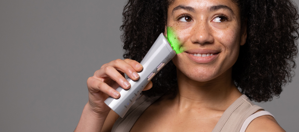 Model holding MAGNITONE FaceRocket to her cheek